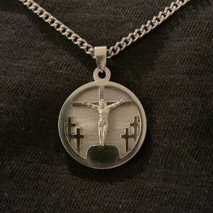 Stainless steel 22’ set of a cross with the Lord’s Prayer in the background